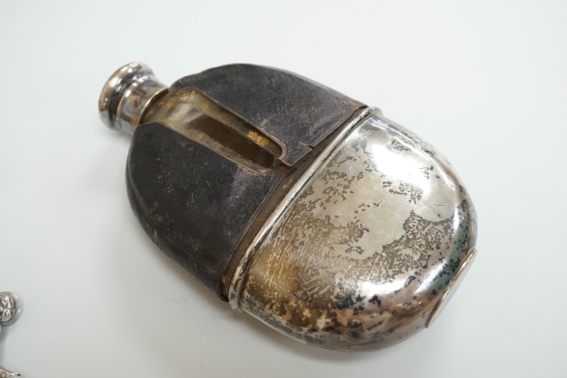 A late 19th century French small white metal Holy Water stoop, 11.4cm, together with a Victorian silver and leather mounted glass hip flask(a.f.), a late Victorian silver 'grenade' lighter by Sampson Mordan & Co, two sil